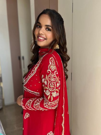 A side profile that shows off her soft waves and the natural, radiant finish of the makeup. It's a perfect example of everyday glam.