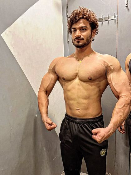 A relaxed front pose showing chest fullness and arm size. Just thinking about the next goal.