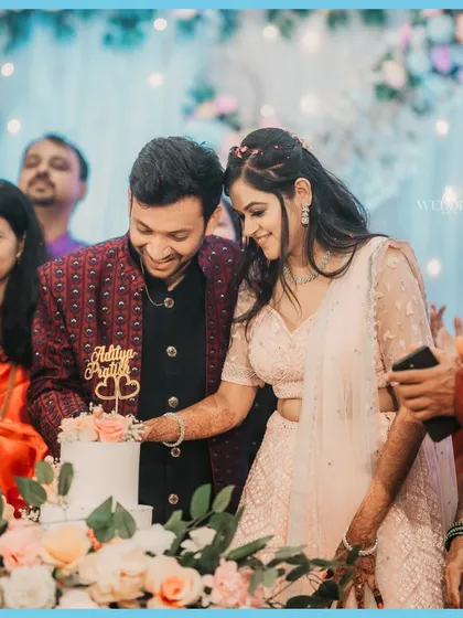 The engagement cake cutting, a sweet beginning to a new journey. The couple is surrounded by the love and blessings of their family.