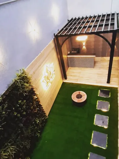 An overhead view showing how the pergola neatly defines the bar and seating area in this narrow backyard space.
