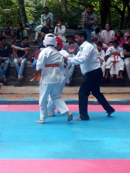 A fast-paced exchange in a junior match. Students learn to move, block, and strike with speed and precision.