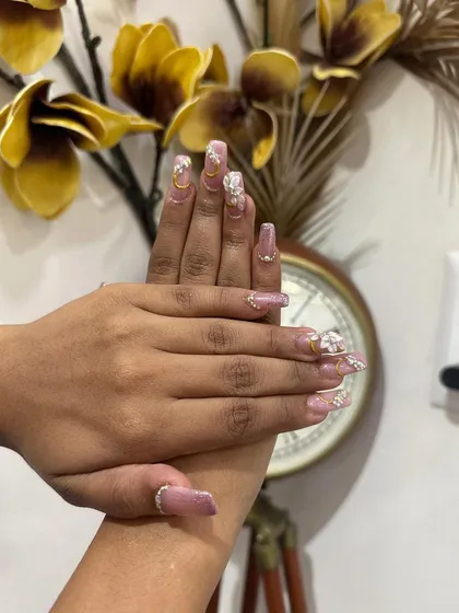 A side view of the intricate bridal manicure, showcasing the dimension of the 3D flowers and the sparkle of the rhinestones.