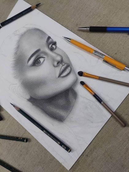 The WIP laid out on my desk with my blending brushes and pencils, showing my process.