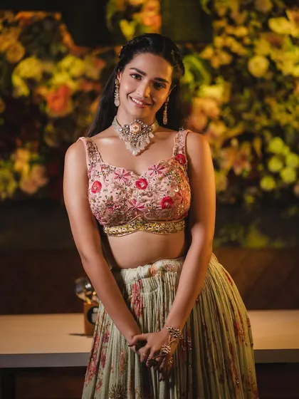 The full look, showing how the fresh makeup complements the beautiful floral lehenga. Perfect for a daytime celebration.