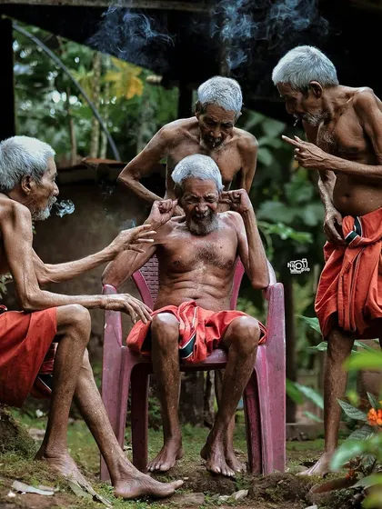 A compelling group portrait that tells a story, capturing a candid moment among elderly men. This represents the powerful documentary and street photography talent within the community.