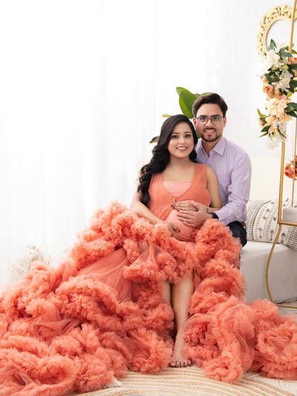 A couple's portrait that beautifully features the dramatic peach gown. The way the ruffles fill the frame adds texture and romance to this intimate shot.