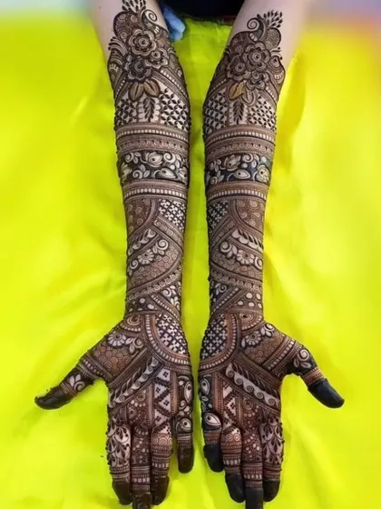 A full-length view of a traditional design with floral bands and jaali work, covering the arms from elbow to fingertips.