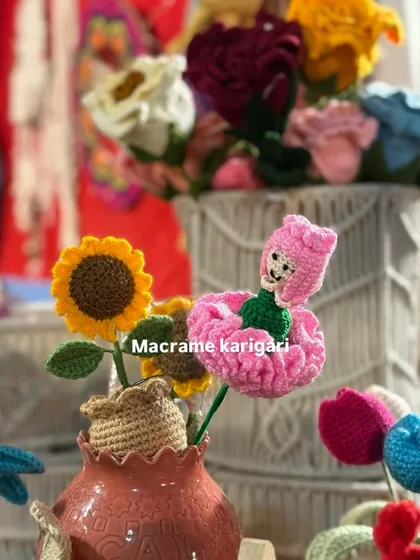 A close-up of our carnation doll alongside a mini sunflower pot. This highlights the variety and creativity within our forever flower collection.
