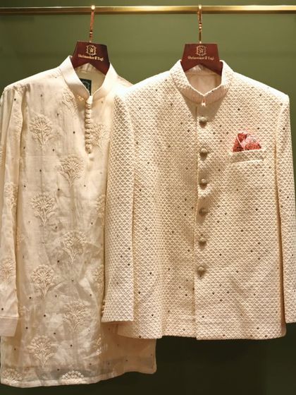 A classic groomswear combination. This pairing features a subtly embroidered kurta and a textured bandhgala jacket, perfect for a sophisticated and timeless wedding day look.