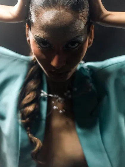 A dramatic close-up from the "Metaverse" shoot, focusing on the metallic eye makeup and the intricate rope braid hairstyle.