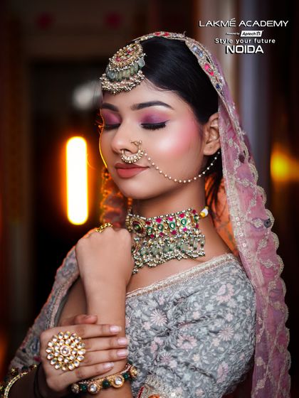 A close-up on the soft pink eye makeup and intricate jewelry, skills that are perfected in our advanced bridal module.