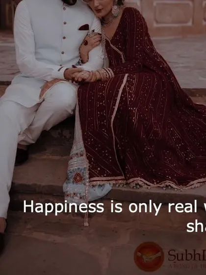 A couple sits closely together, holding hands. This simple image shows that happiness is most real when it is shared with the right person.
