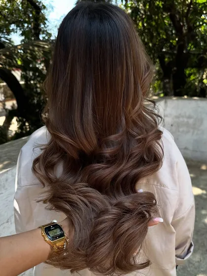 Another beautiful holiday hair transformation. We refreshed her color with a mix of beige and ash tones for a cool, sophisticated brunette look.