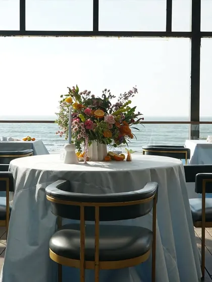 A beautiful tablescape for a seaside cocktail party, with a stunning view of the ocean.