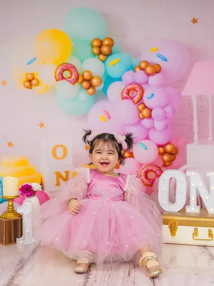 A full, happy smile that says it all. My goal is to create a fun atmosphere where kids can be themselves, resulting in genuine expressions like this.