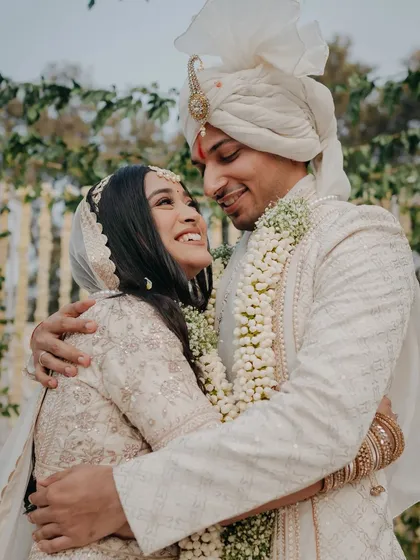 A beautiful, candid moment of the couple embracing, their faces lit up with joy. This is the kind of authentic, love-filled image we strive to capture.