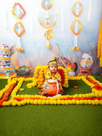 Tiny Krishna tales, told with flowers and festive colors. This beautiful setup with marigold garlands and painted matkis is the perfect backdrop for a Janmashtami celebration.