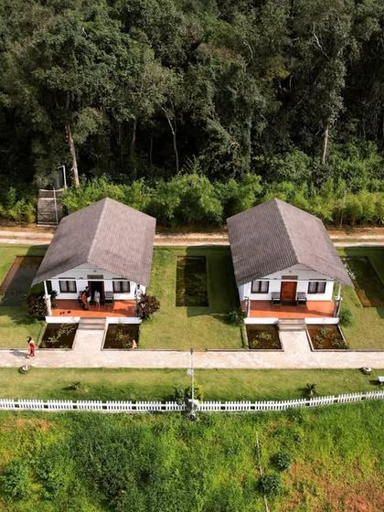 A beautiful row of cottages surrounded by greenery, another type of comfortable accommodation we offer on our trips.