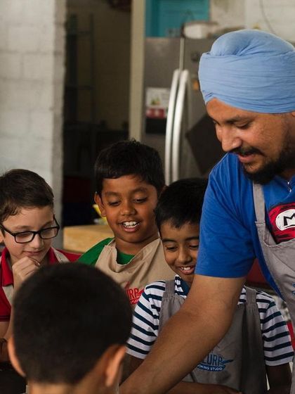 Our chef guiding a group of curious young minds. We love their enthusiasm and endless questions, and we aim to nurture that curiosity about food and cooking.