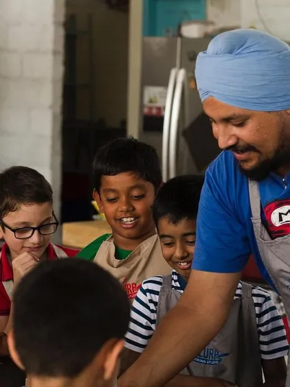 Our chef guiding a group of curious young minds. We love their enthusiasm and endless questions, and we aim to nurture that curiosity about food and cooking.