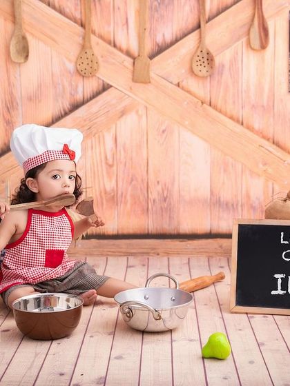 Tasting the wooden spoon is all part of the fun in a 'Little Chef' photoshoot. I love capturing these silly, real moments.