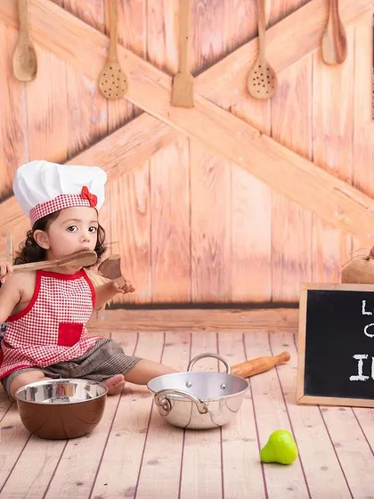 Tasting the wooden spoon is all part of the fun in a 'Little Chef' photoshoot. I love capturing these silly, real moments.