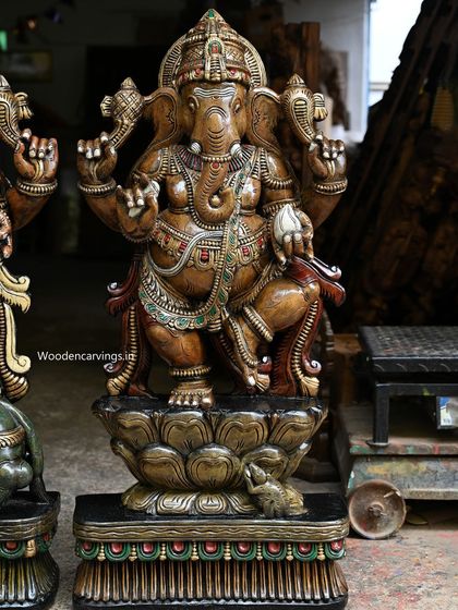 A close-up of the 42-inch Ganesha dancing on a lotus, detailing the vibrant, antique color finish.