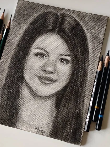 The Selena Gomez portrait displayed with the Faber-Castell and Camlin pencils used to create it.