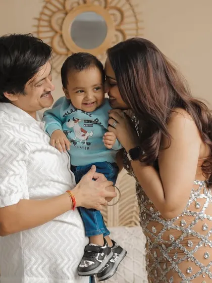 A candid moment of pure family bliss. The parents shower their little boy with affection, and his joyful smile is absolutely infectious. This is the unposed magic I love to capture in the studio.