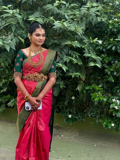 A full-length shot of Ragavi, showcasing her elegant posture and the beautiful drape of her saree. Her makeup is understated, allowing her natural beauty to be the focus.