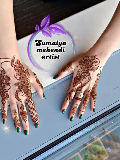 The same party henna designs, showing the client's happiness.