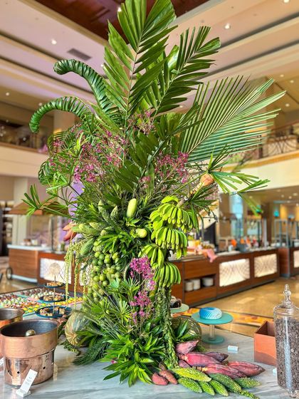 This shot shows how the arrangement integrates with the buffet, with desserts and dishes placed amongst the greenery.