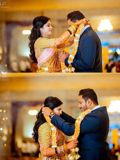 The couple exchanging garlands at their reception, a beautiful moment of welcome.