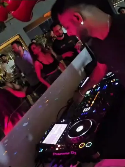 A candid, angled shot of me at the decks, with the crowd visible in the background.