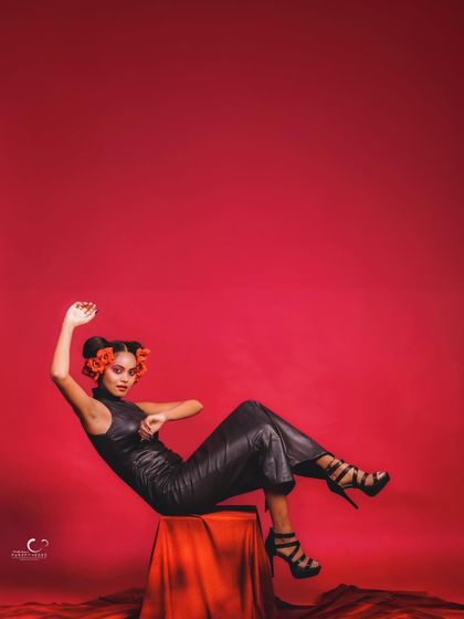 A creative and unconventional seated pose that feels like a high-fashion editorial. The composition is bold and memorable.