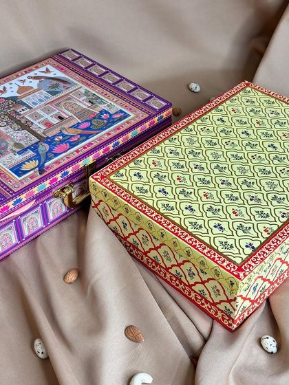Here are two of my square-shaped designer boxes, featuring intricate traditional patterns. These are perfect for packing dry fruits, chocolates, or a mix of other goodies for a rich, festive look.