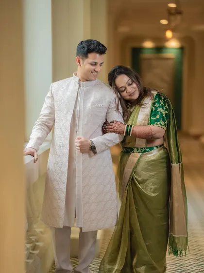 A quiet, tender moment between Shami and Udit in an elegant hotel corridor. The soft light and her gentle lean create a very romantic mood.