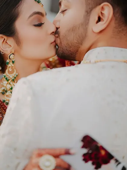 A close-up of their kiss. This shot highlights the durability and flawless finish of her makeup, designed to last through every part of the wedding day.