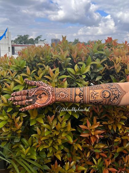 A side view of the engagement mehendi, showing the detail on the arm which includes the couple's initials and an elephant motif.