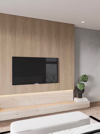 A minimalist bedroom design where the focus is on clean lines and natural materials. The light wood media wall with integrated backlighting provides a warm and uncluttered focal point opposite the bed.