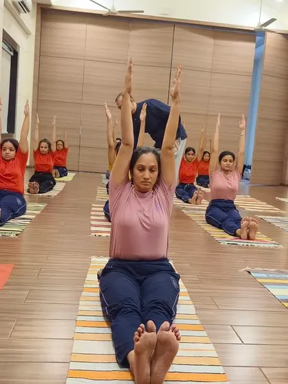 A glimpse into the synchronized discipline of our group yoga sessions. We focus on correct alignment and mindful movement, helping students build a strong and stable foundation for their practice.