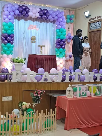 A wider view of the pastel first birthday party, showing the full stage and how the elements come together in the event space.