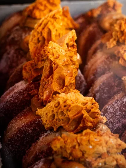 Honeycomb candy donuts from Bread Ahead Bakery. The close-up shot captures the unique, airy texture of the honeycomb.