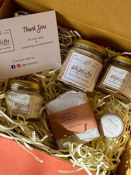 A finished gift box, ready to be sent. It’s filled with a curated selection of our products, cushioned with recycled paper shreds, and includes a thank you card. This is what mindful, sustainable gifting looks like.