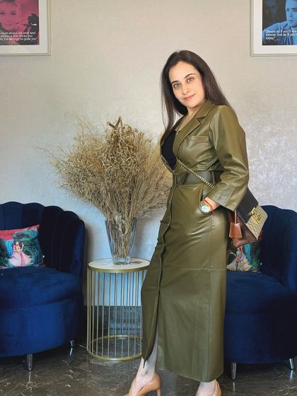 When the weather cools down, it's time to bring out the faux leather. I love this olive green trench dress for its sophisticated silhouette and edgy texture, making it a real statement piece.