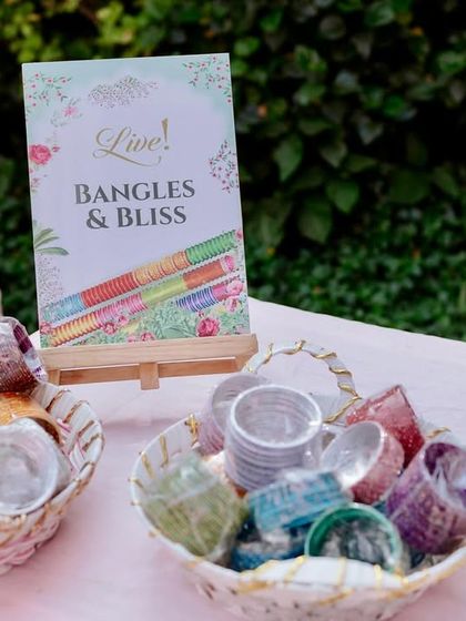 A "Bangles & Bliss" station, offering guests a variety of colorful bangles as party favors. This is another example of how I create engaging experiences within the decor.