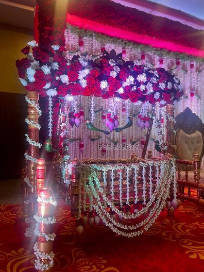 A close-up of the cradle, adorned with red roses and white jasmine garlands. The attention to detail in our cradle decorations ensures a beautiful and safe space for the baby.