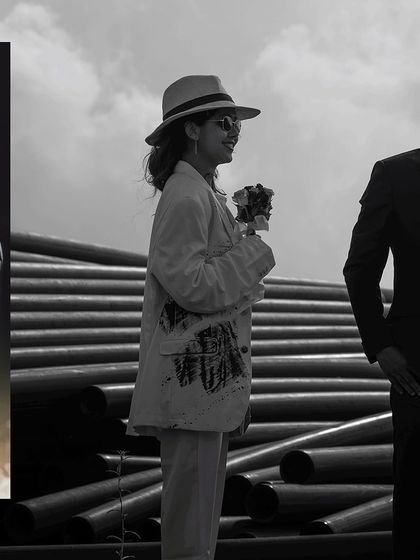 A stylish black and white shot capturing the couple's fashionable outfits and confident poses in an unconventional setting.