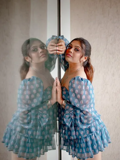 A creative portrait using a mirror reflection. The model's pose and the reflection create an artistic and visually interesting image.