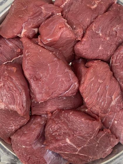 A close-up of the boneless buffalo meat chunks, showing the quality and leanness of the cut.
